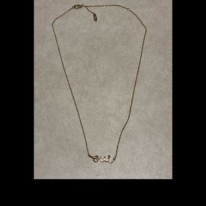 Gold toned necklace with cursive script French word “Oui”, 15-19”, like new!